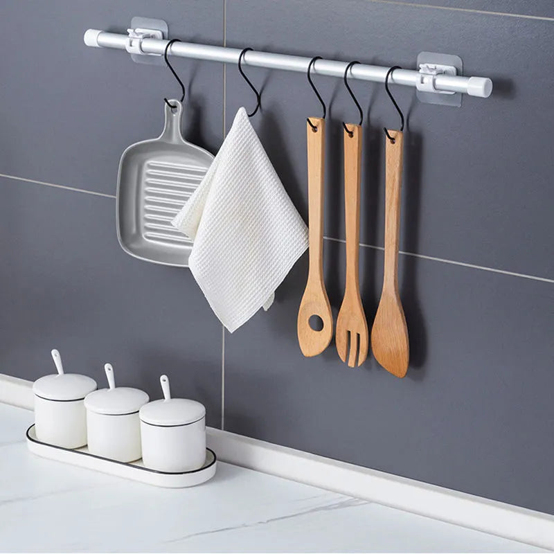 Self-adhesive hooks for hanging curtain rods without punching holes. Ideal for securing shower curtains and other household items